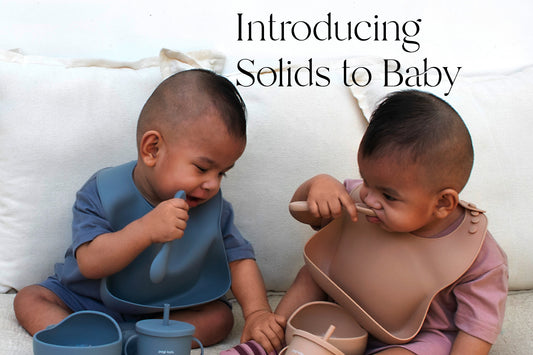 two babies are playing with Silicone Baby Feeding Set modeling Introducing Solids to Baby: Tips for a Smooth Transition