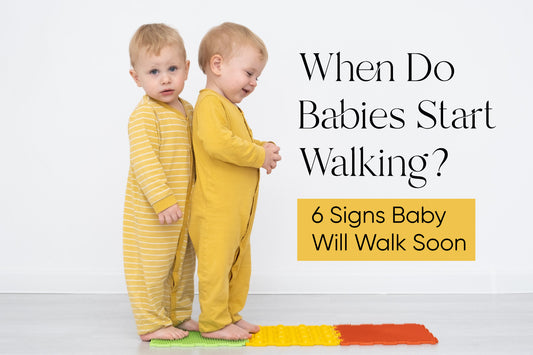 Blonde toddlers standing on an orthopedic Mat for the blog post titled When Do Babies Start Walking? 6 Signs Baby Will Walk Soon