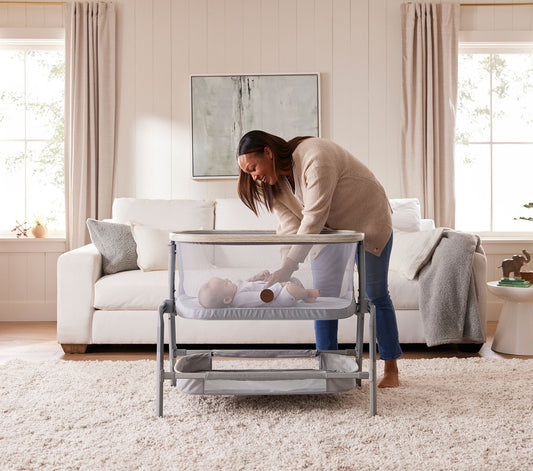Maxi-Cosi® Iora Newborn Bassinet with a large storage basket, showcasing its sleek design and sturdy frame.