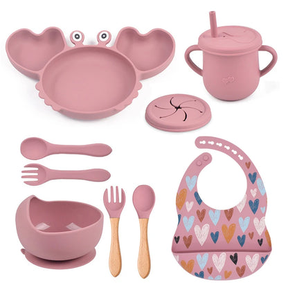 dark pink variant of 9-piece best silicone baby feeding set including a non-slip suction bowl, plate, spoon, waterproof bib, cup, and crab-shaped dishes. BPA-free and designed for children aged 7-36 months, this dinnerware set ensures safe and mess-free mealtime.