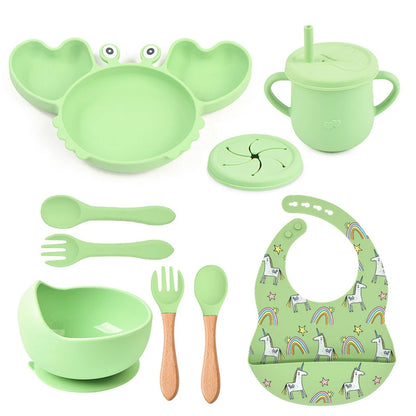 green variant of 9-piece best silicone baby feeding set including a non-slip suction bowl, plate, spoon, waterproof bib, cup, and crab-shaped dishes. BPA-free and designed for children aged 7-36 months, this dinnerware set ensures safe and mess-free mealtime.