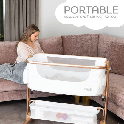 A mother put her baby into KoolaBaby® DreamWeave™ Portable Bassinet
