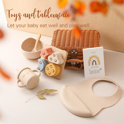 toys showing Meow and Grow™ Baby Gift Set featuring a silicone bib, cat cup, and wooden rainbow stacker in a vintage-style gift box