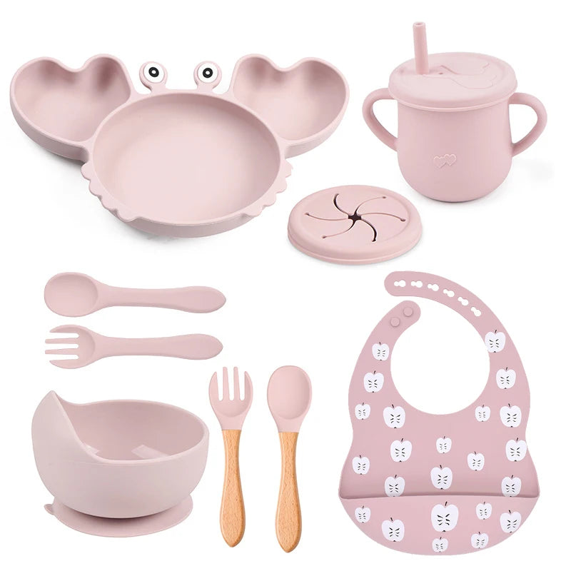 light baby pink variant of 9-piece best silicone baby feeding set including a non-slip suction bowl, plate, spoon, waterproof bib, cup, and crab-shaped dishes. BPA-free and designed for children aged 7-36 months, this dinnerware set ensures safe and mess-free mealtime.