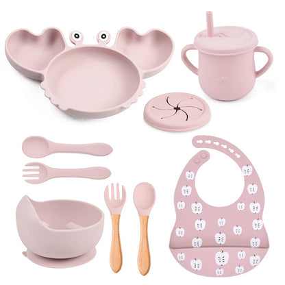 light baby pink variant of 9-piece best silicone baby feeding set including a non-slip suction bowl, plate, spoon, waterproof bib, cup, and crab-shaped dishes. BPA-free and designed for children aged 7-36 months, this dinnerware set ensures safe and mess-free mealtime.