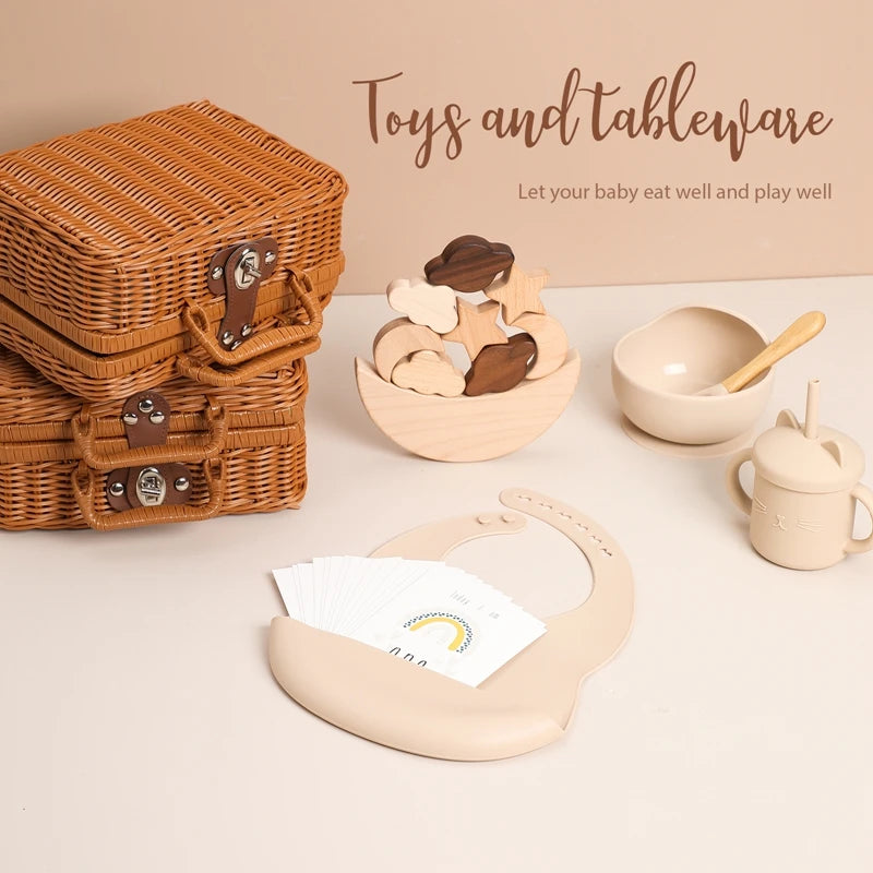 toys set showing in a table of Meow and Grow™ Baby Gift Set featuring a silicone bib, cat cup, and wooden rainbow stacker in a vintage-style gift box
