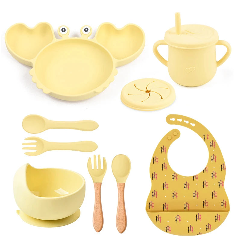 yellow variant of 9-piece best silicone baby feeding set including a non-slip suction bowl, plate, spoon, waterproof bib, cup, and crab-shaped dishes. BPA-free and designed for children aged 7-36 months, this dinnerware set ensures safe and mess-free mealtime.