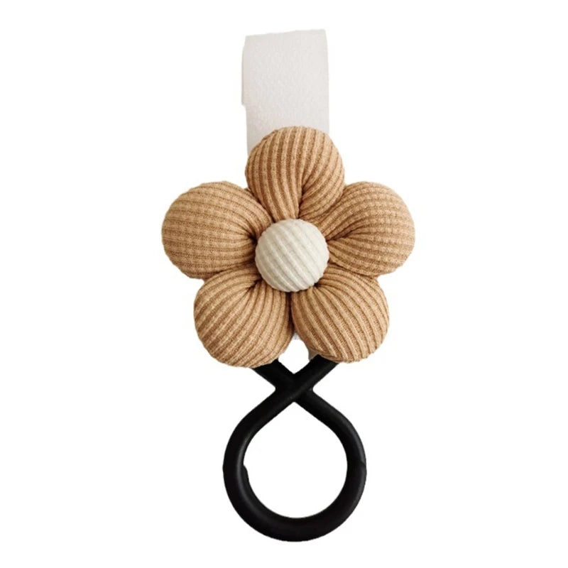 BloomLoop™ Baby Stroller Hook in Brown - Versatile stroller accessory with a small flower pattern for extra storage.