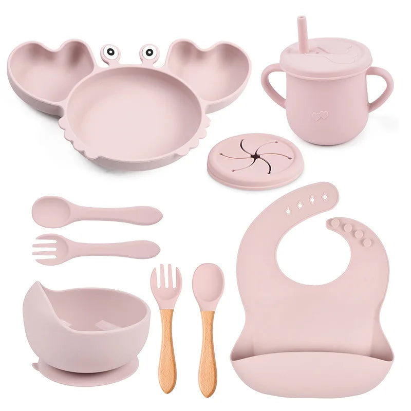 light pink variant of 9-piece best silicone baby feeding set including a non-slip suction bowl, plate, spoon, waterproof bib, cup, and crab-shaped dishes. BPA-free and designed for children aged 7-36 months, this dinnerware set ensures safe and mess-free mealtime.