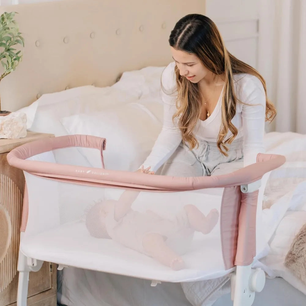 mother looking at her baby in Baby Delight BassiNest Luxury Bassinet