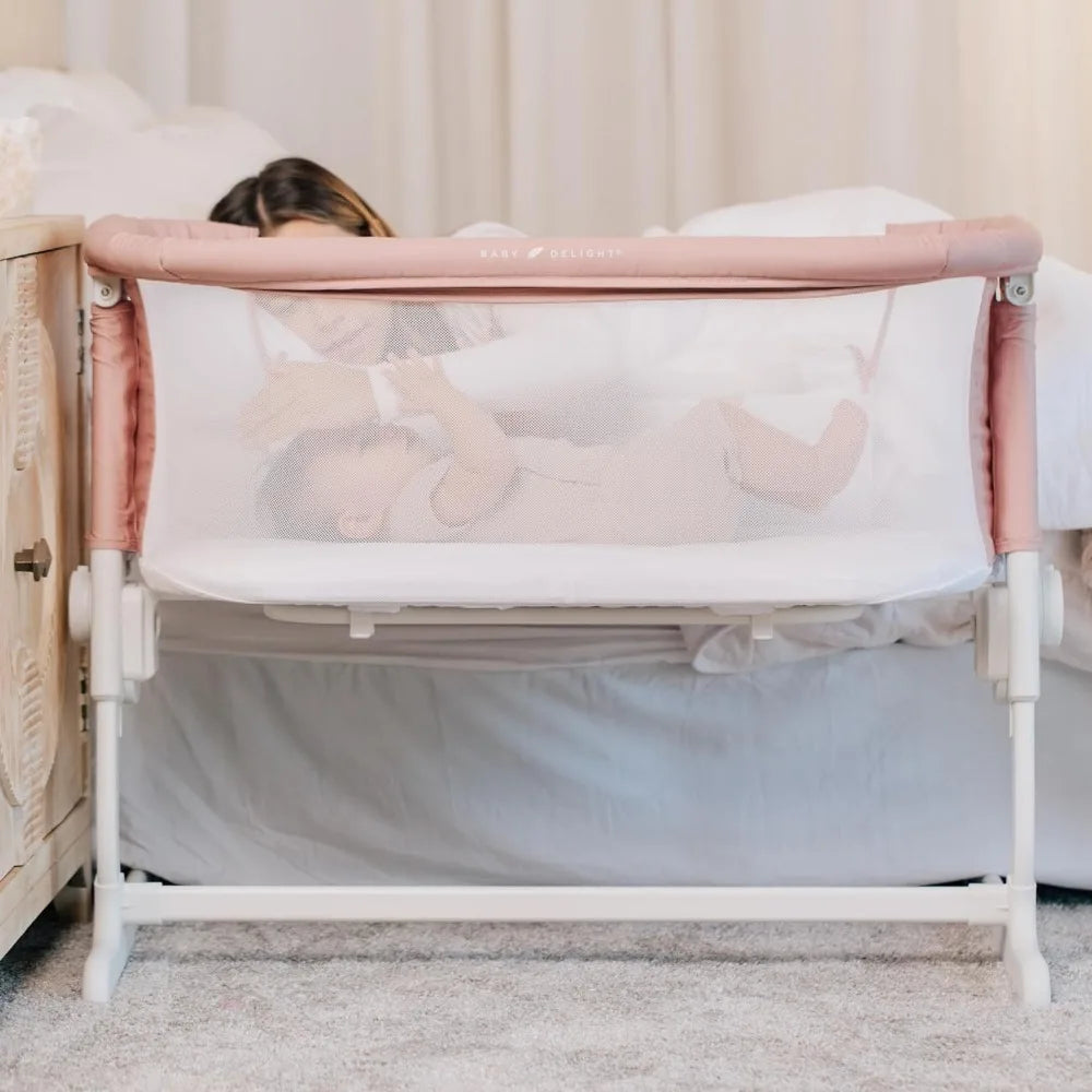 mother playing with her baby in Baby Delight BassiNest Luxury Bassinet