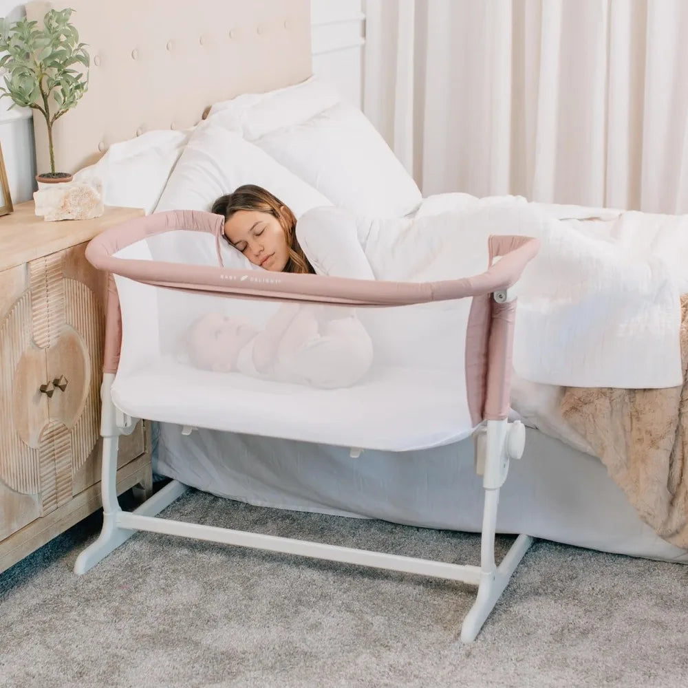 mother sleeping while her baby is sleeping on Baby Delight BassiNest Luxury Bassinet